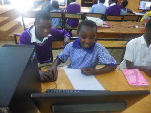 Derrick (left) at a computer lesson conducted by Fundi Bots